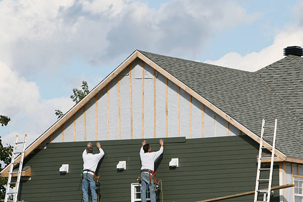 Professional Storm Damage Siding Repair technician working in McClellandtown, PA